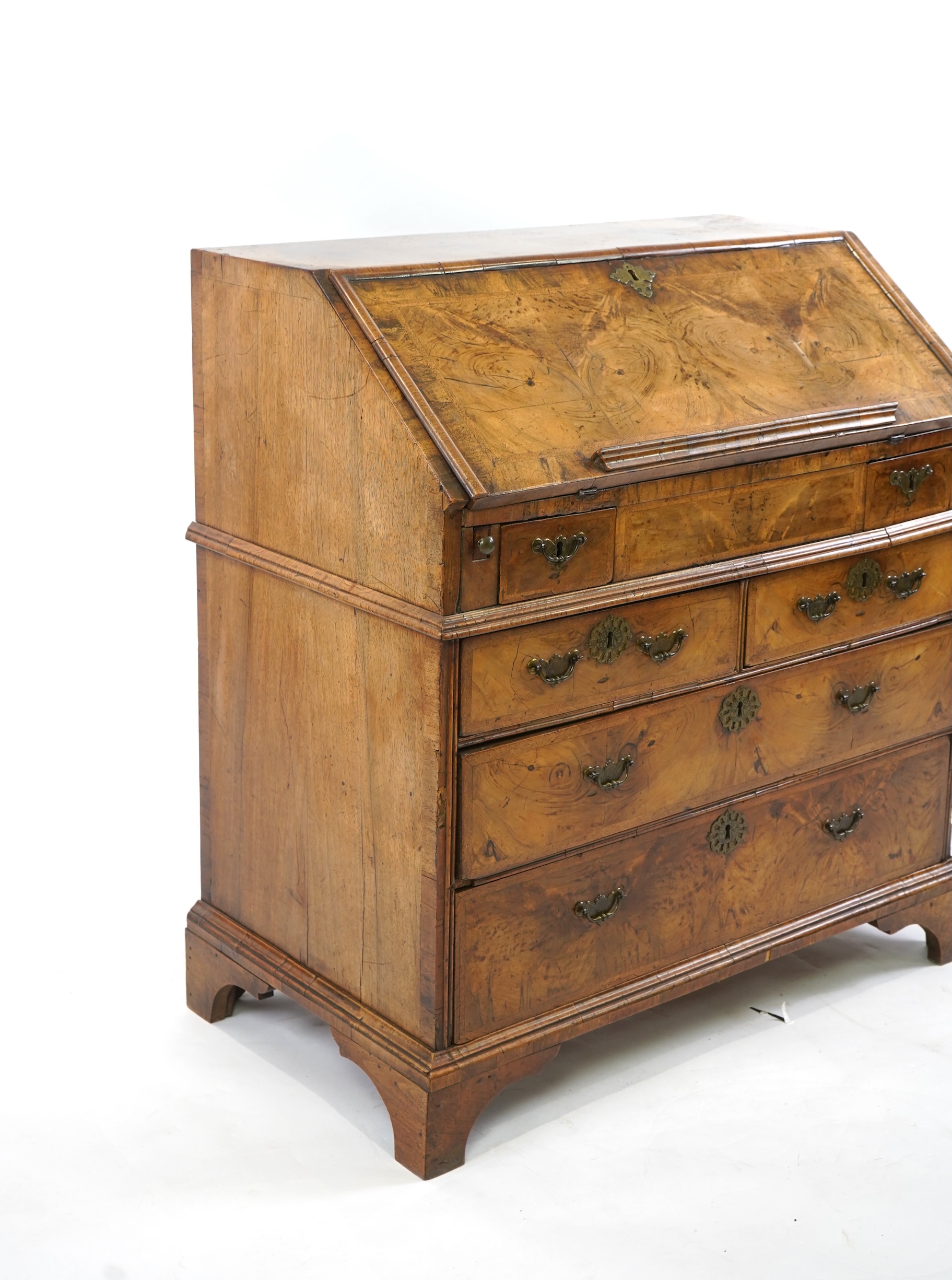 A George I feather banded walnut bureau